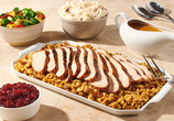 Image shows the Thanksgiving Dinner Bundle featuring tender-carved turkey breast, savory bread stuffing, red-skinned mashed potatoes, turkey gravy, cranberry sauce, and a choice of a second side including herb-glazed corn, fresh vegetable medley, and new for this year, creamy mac and cheese.