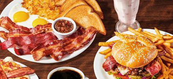 Denny's baconalia menu with triple bacon sampler. bacon obsession burger, bacon pancakes and bacon milkshake with a cup of coffee