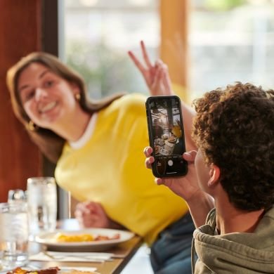Two guests in restaurant with their phone 
